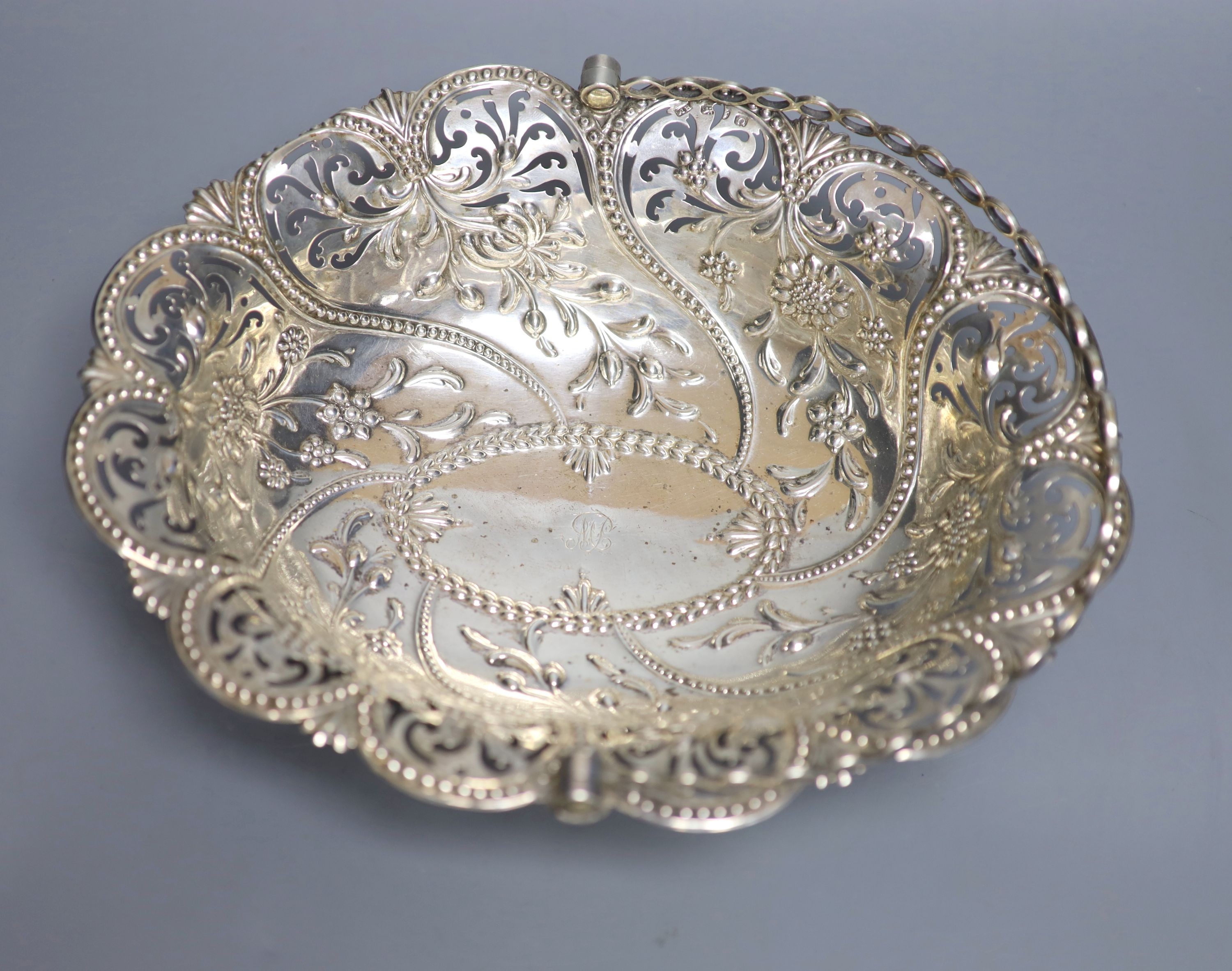 An early George III silver basket, with later? pierced and embossed decoration, Richard Meach, London, 1768, length 30.8cm, 21oz.